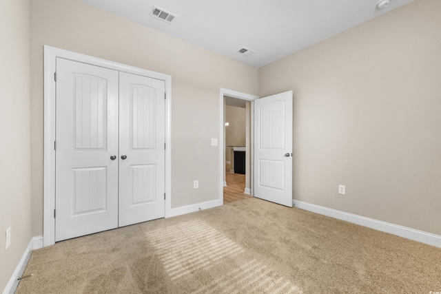 unfurnished bedroom featuring a closet and carpet