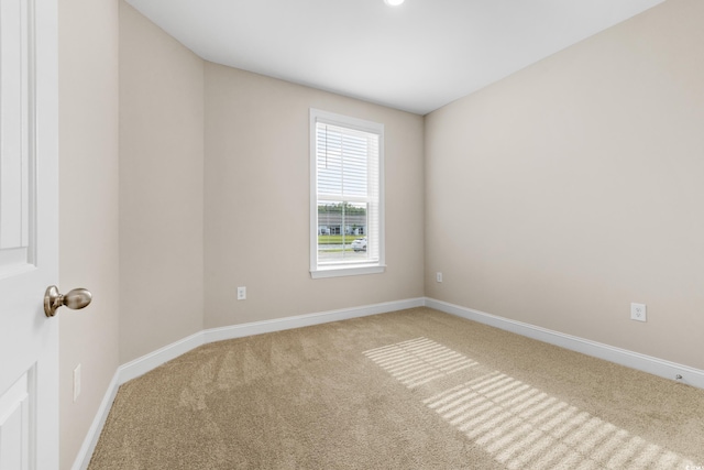 spare room with light carpet