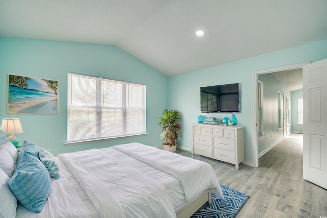 bedroom with light wood-type flooring and lofted ceiling