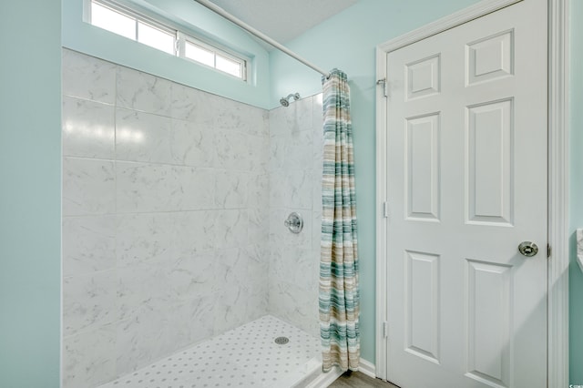 bathroom featuring hardwood / wood-style floors and walk in shower