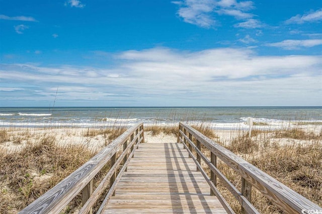 view of property's community featuring a view of the beach and a water view