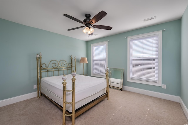 bedroom with ceiling fan and light carpet