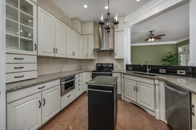 kitchen featuring ceiling fan with notable chandelier, sink, stainless steel appliances, and dark stone counters