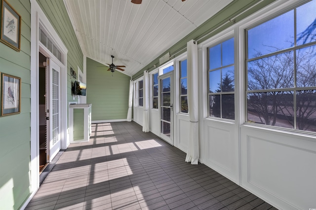 unfurnished sunroom featuring ceiling fan, wooden ceiling, and vaulted ceiling