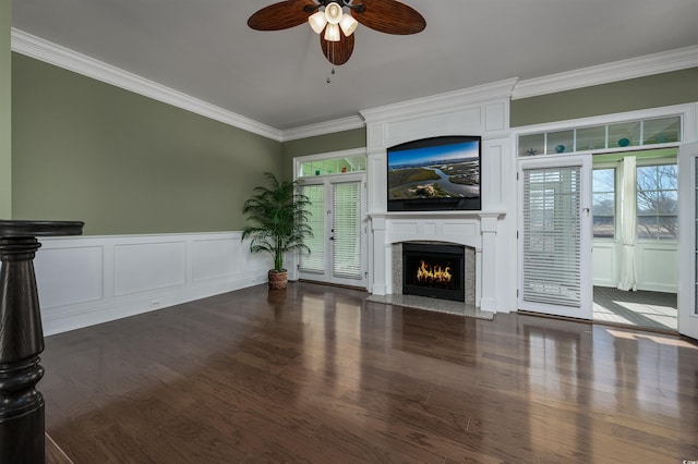 unfurnished living room featuring dark hardwood / wood-style floors, ceiling fan, and ornamental molding