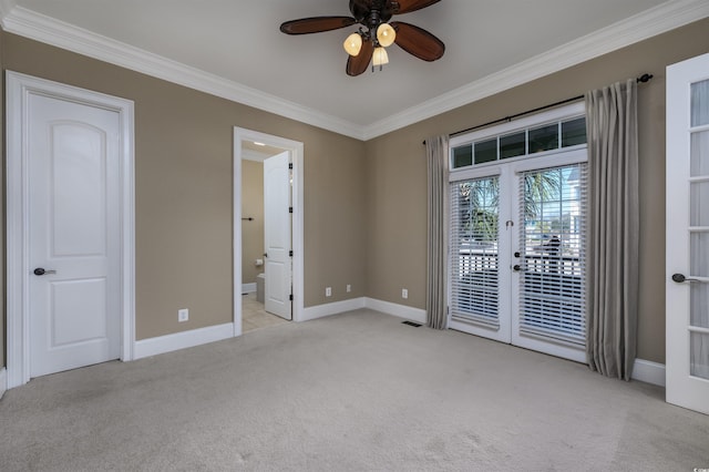 carpeted empty room featuring ceiling fan, french doors, and ornamental molding