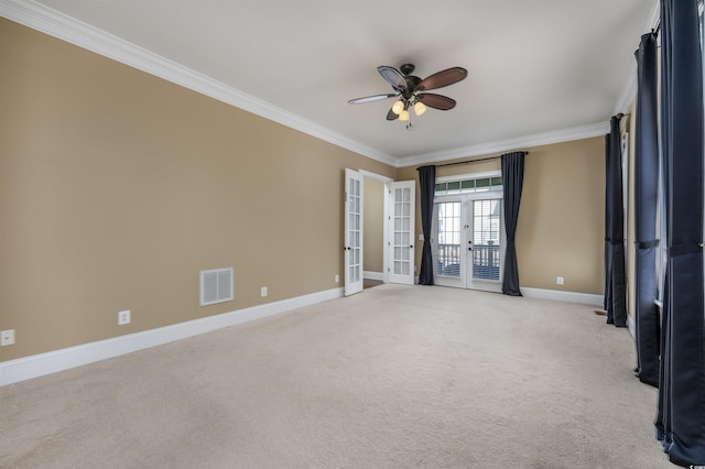 spare room with light carpet, french doors, ceiling fan, and crown molding