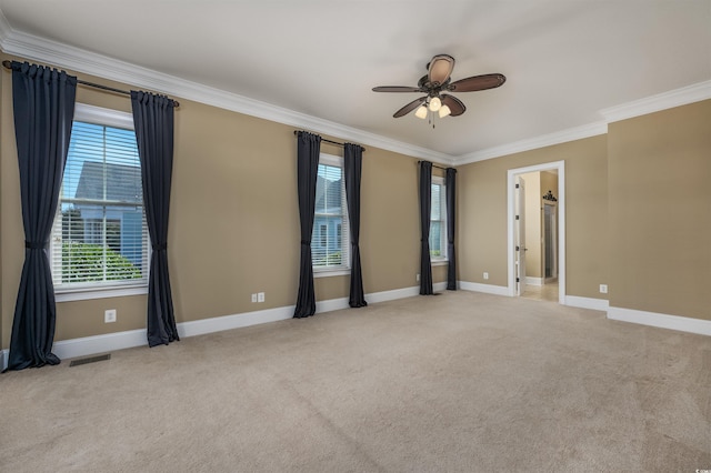 carpeted empty room featuring crown molding and ceiling fan