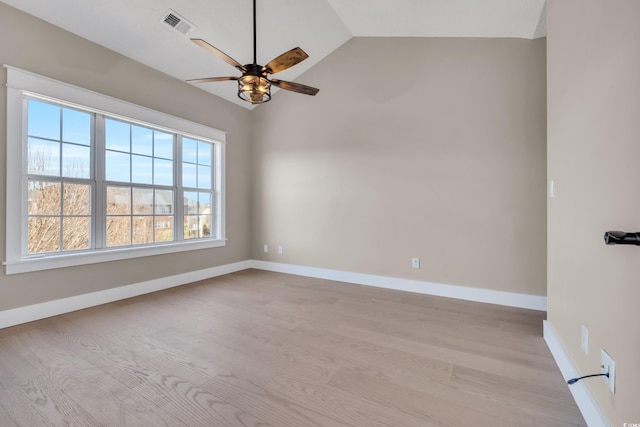 unfurnished room with ceiling fan, visible vents, baseboards, vaulted ceiling, and light wood finished floors