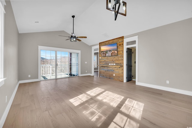 unfurnished living room featuring baseboards, vaulted ceiling, light wood finished floors, and ceiling fan