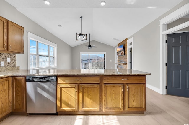 kitchen with light stone counters, a healthy amount of sunlight, vaulted ceiling, and stainless steel dishwasher