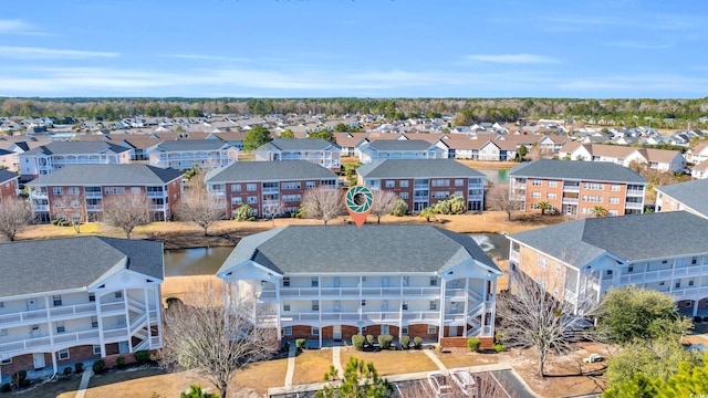 birds eye view of property featuring a residential view and a water view