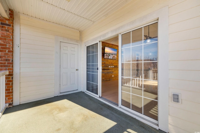 entrance to property featuring brick siding