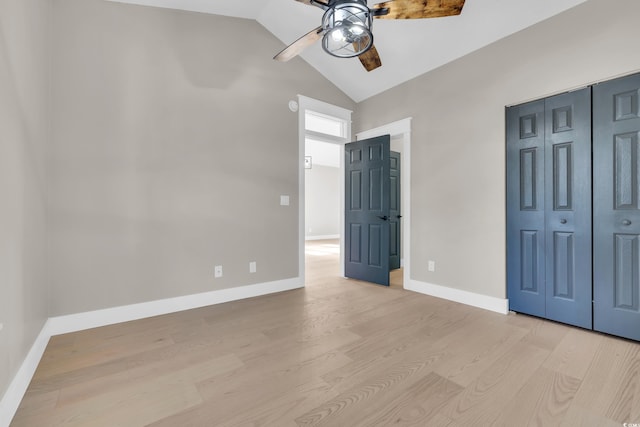 unfurnished bedroom featuring baseboards, a closet, a ceiling fan, and light wood-style floors