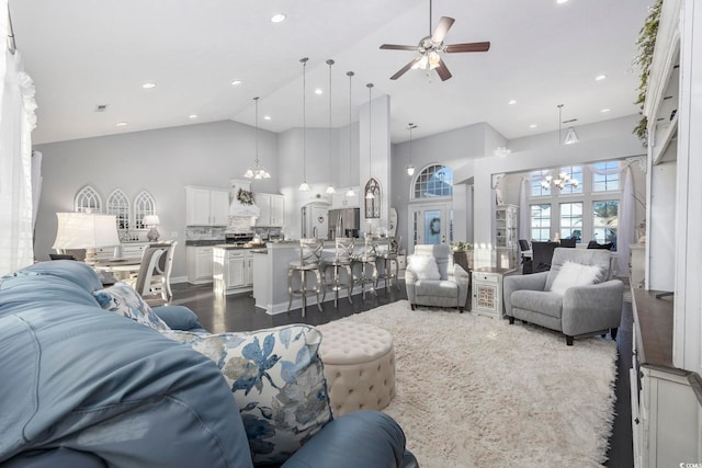 living room with ceiling fan, dark hardwood / wood-style flooring, and high vaulted ceiling