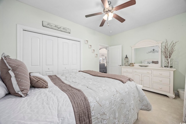 carpeted bedroom with ceiling fan and a closet