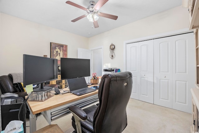 carpeted office featuring ceiling fan