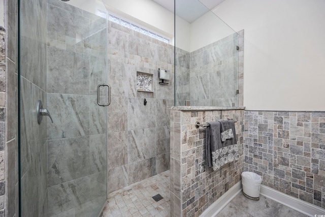 bathroom featuring a shower with shower door