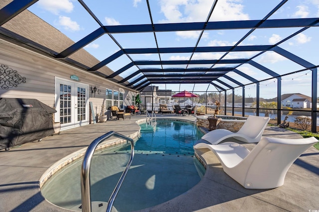 view of swimming pool featuring an in ground hot tub, french doors, glass enclosure, and a patio area