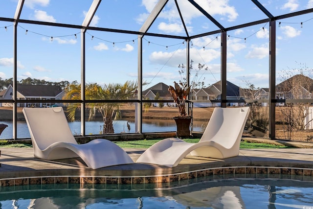 view of pool featuring a water view, glass enclosure, and a water slide