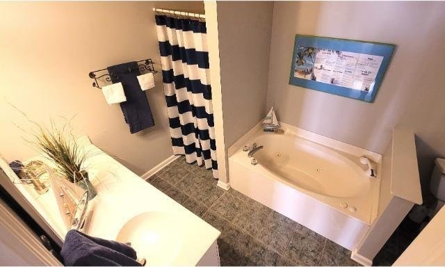 bathroom with a tub to relax in