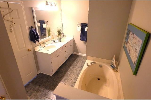 bathroom with vanity and a bathtub