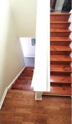 stairs with hardwood / wood-style flooring