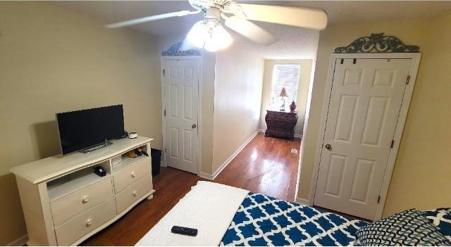 bedroom featuring dark hardwood / wood-style flooring and ceiling fan