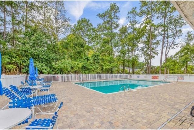 view of swimming pool featuring a patio area