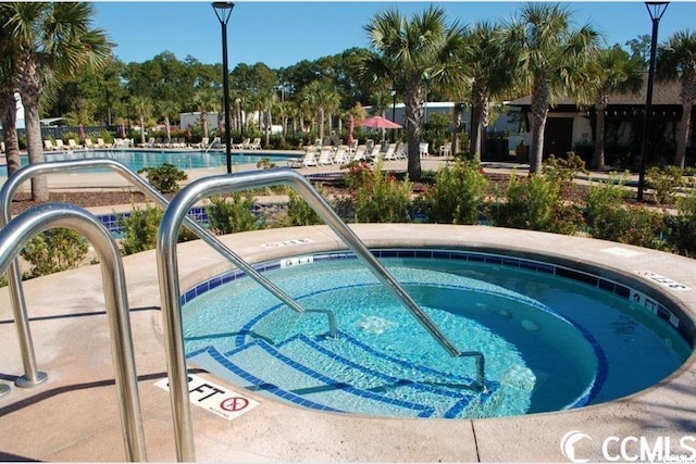 view of swimming pool with a community hot tub