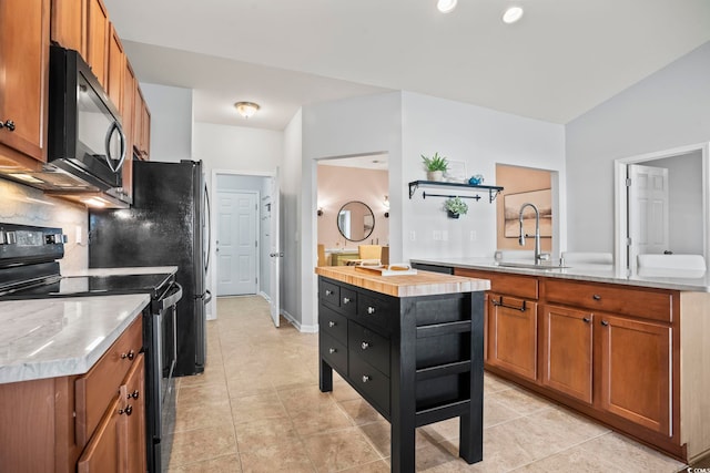 kitchen with light tile patterned floors, brown cabinetry, black appliances, a sink, and decorative backsplash