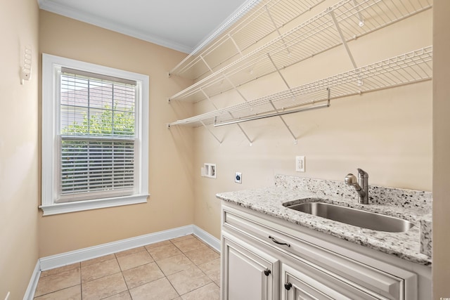 laundry area with crown molding, sink, washer hookup, hookup for an electric dryer, and light tile patterned flooring