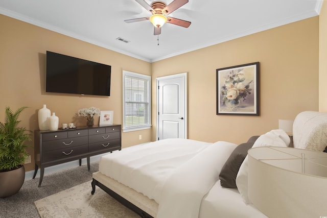 carpeted bedroom with ceiling fan and crown molding