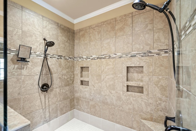 bathroom featuring a tile shower and crown molding