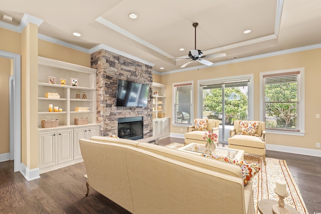 living room with a tray ceiling and dark hardwood / wood-style floors