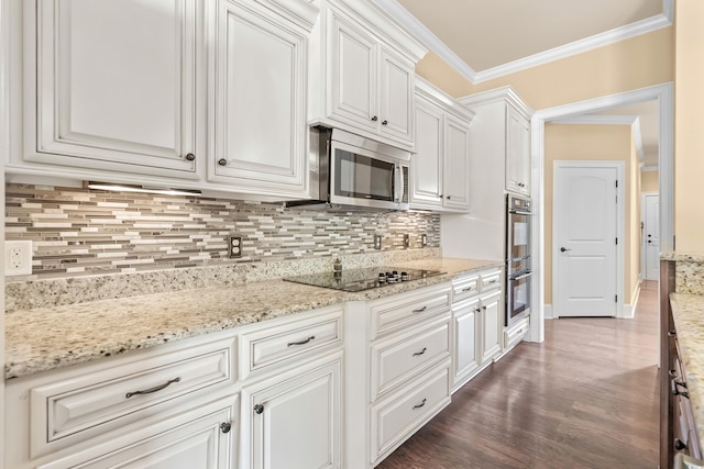 kitchen with backsplash, white cabinets, crown molding, light stone counters, and stainless steel appliances