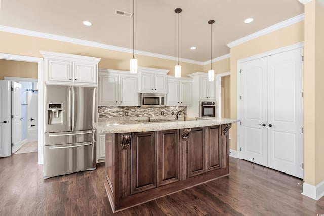 kitchen with decorative light fixtures, light stone counters, white cabinetry, and stainless steel appliances