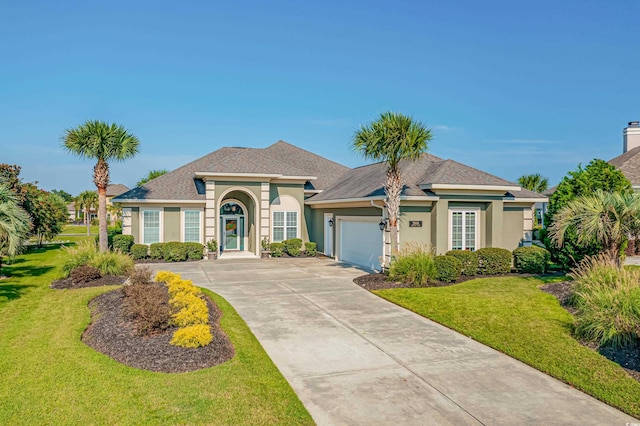 view of front of home featuring a garage and a front yard