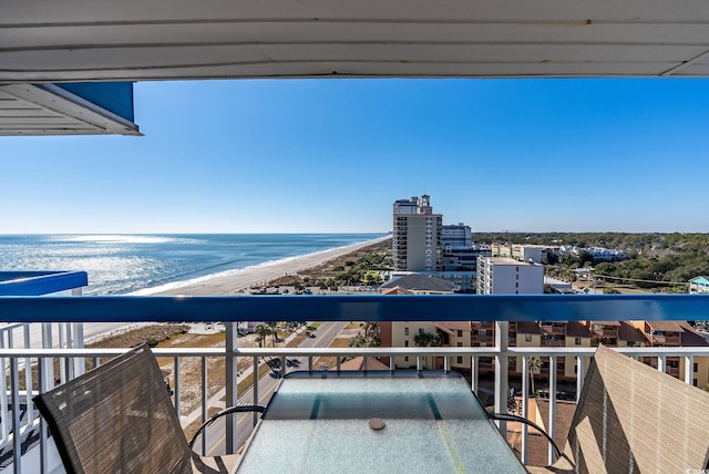 balcony featuring a water view and a beach view