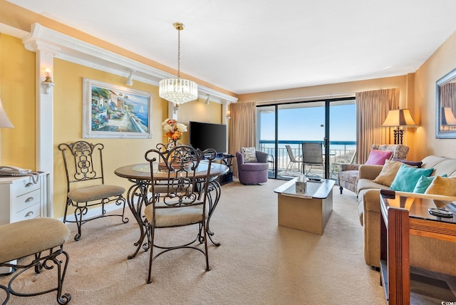 dining room with light carpet and a chandelier