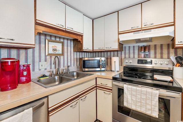 kitchen with white cabinets, stainless steel appliances, and sink