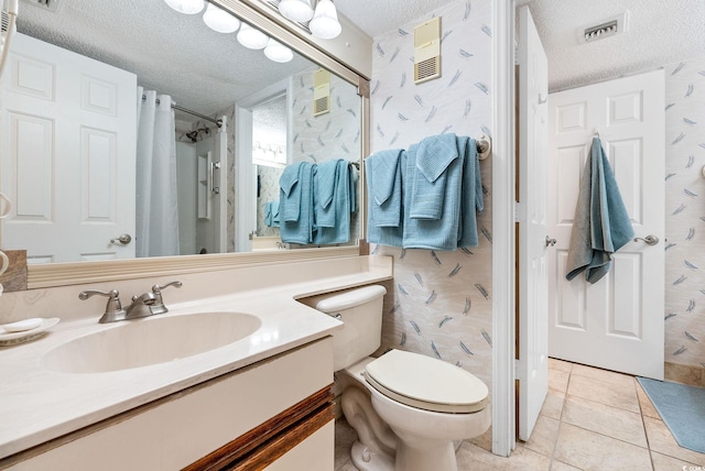 bathroom featuring a shower with curtain, vanity, a textured ceiling, tile patterned flooring, and toilet