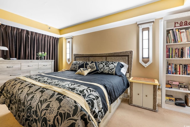 bedroom with light colored carpet and multiple windows