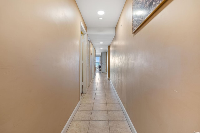 hall featuring light tile patterned flooring