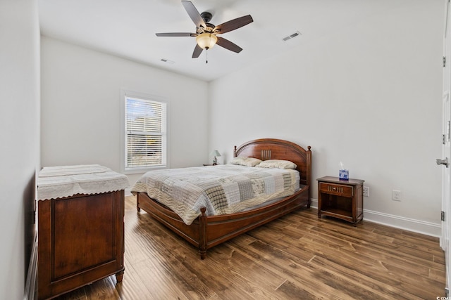 bedroom featuring dark wood-style floors, baseboards, visible vents, and ceiling fan