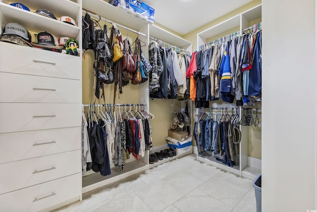 spacious closet featuring light tile patterned floors