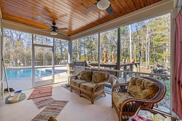 sunroom with wood ceiling and a ceiling fan