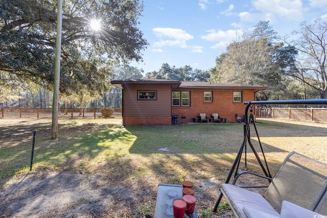 back of house with a lawn