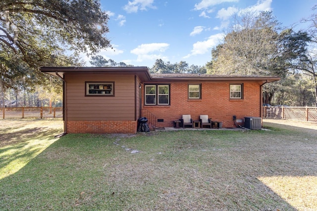 back of house with a lawn and central air condition unit