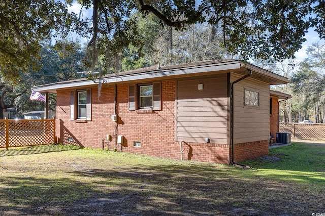 view of home's exterior featuring a yard and central AC unit